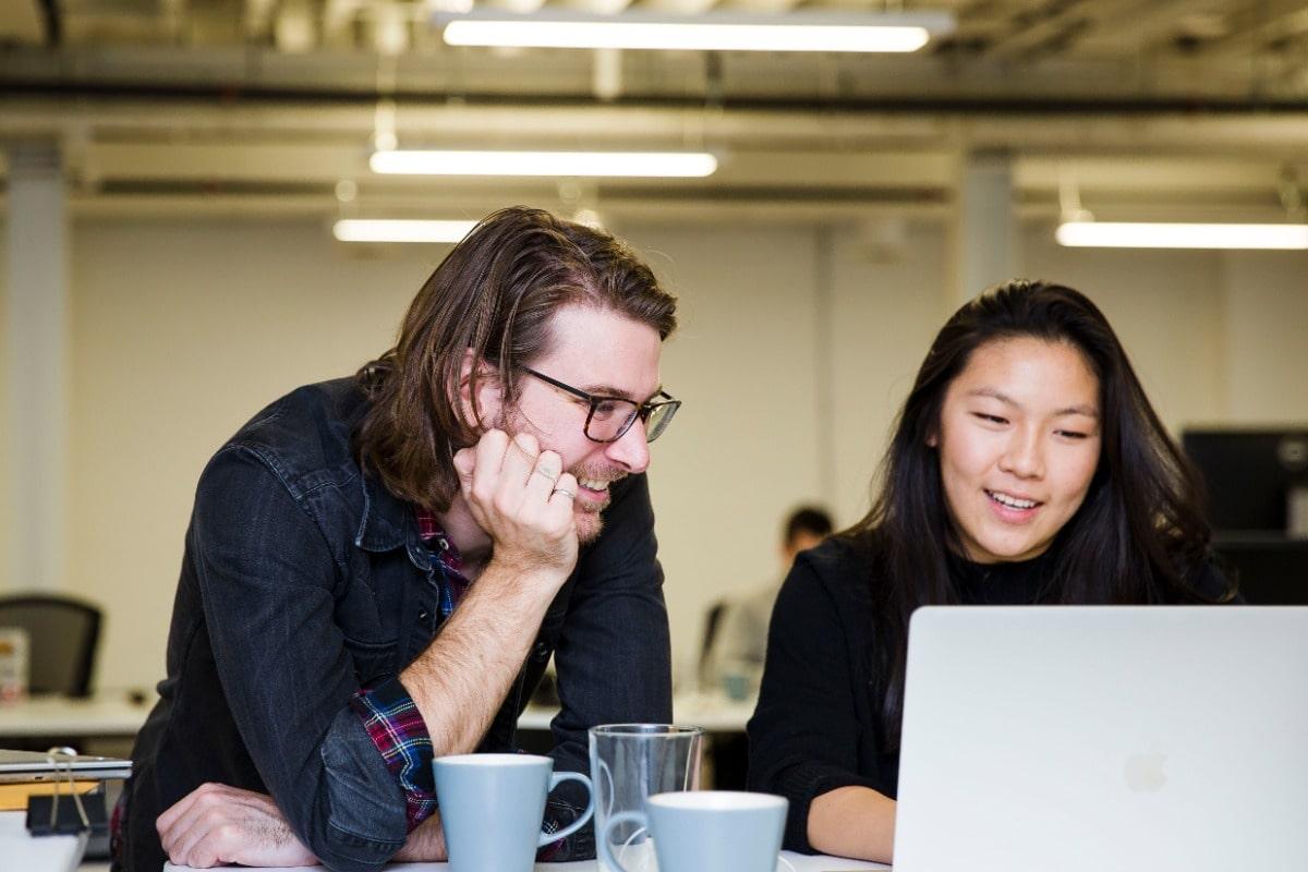 Two engineers working together on laptop